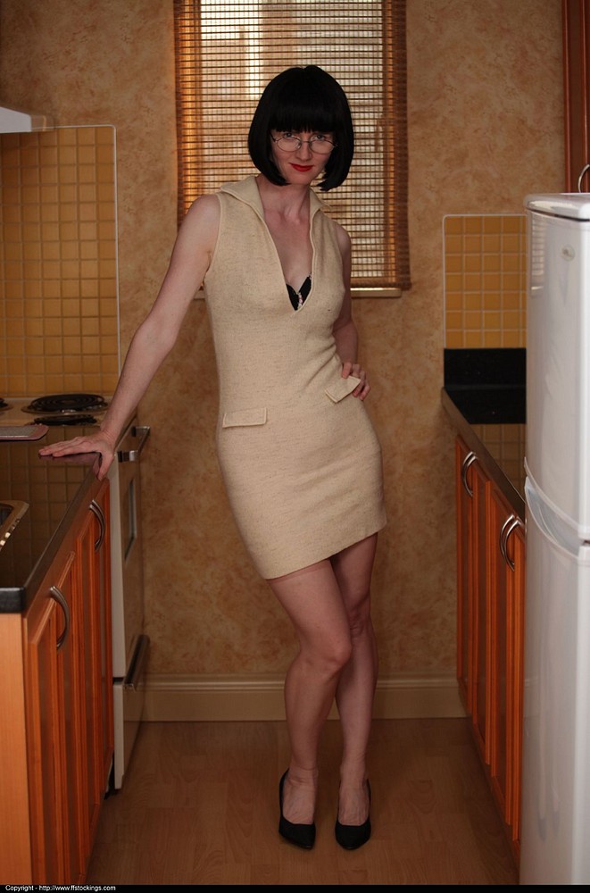 Mature in stockings shows striptease in kitchen